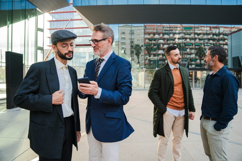 Group of businessmen watching the investment on a cellphone. Business people using a smartphone to